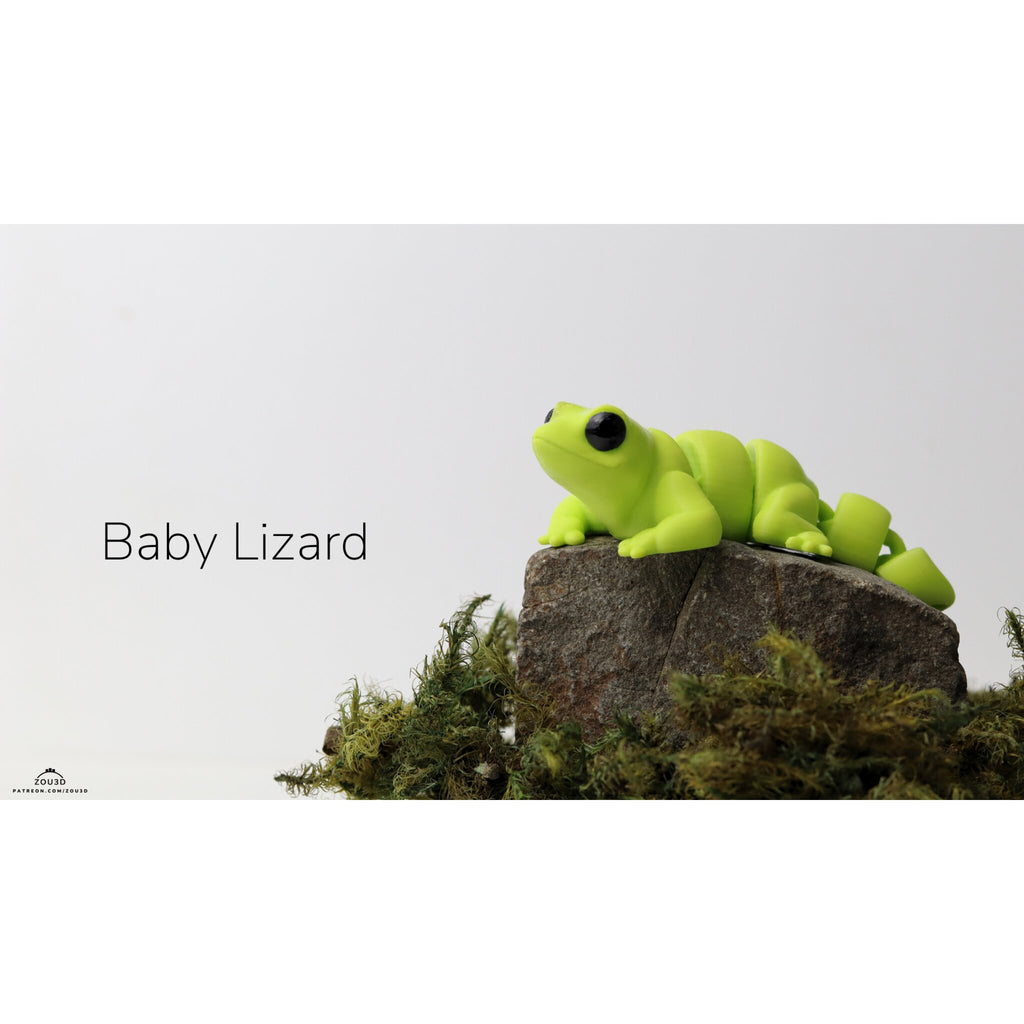 Baby Lizard (ZOU3D) articulated fidget toy — official render, front angle on mossy rock