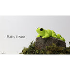 Baby Lizard (ZOU3D) articulated fidget toy — official render, front angle on mossy rock