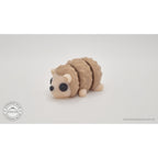 Baby Hedgehog articulated 3D printed toy — 3/4 front view showing face, legs, and quill texture, own photo by Sensory Sidequest