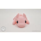 Pink Tiny Dragon 3D printed fidget toy — 3/4 front view showing horns and expressive eyes — Sensory Sidequest Australia