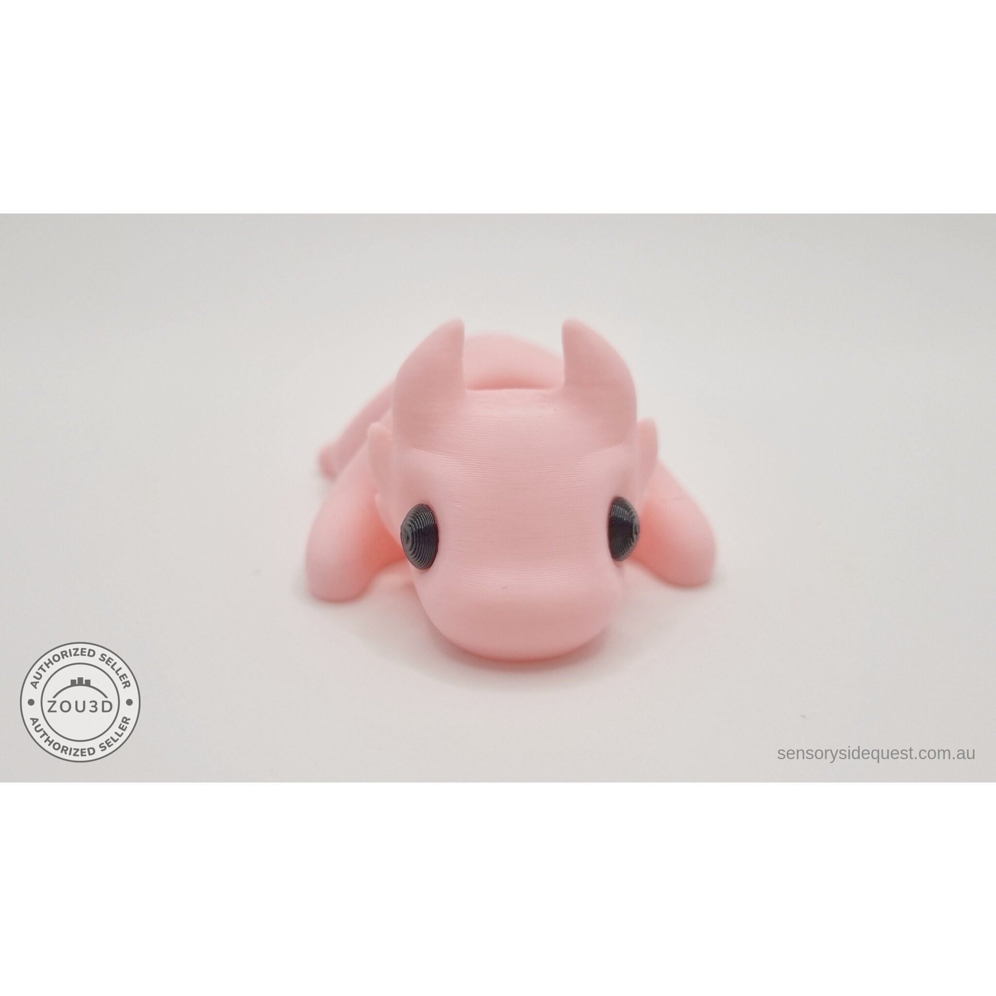 Pink Tiny Dragon 3D printed fidget toy — 3/4 front view showing horns and expressive eyes — Sensory Sidequest Australia