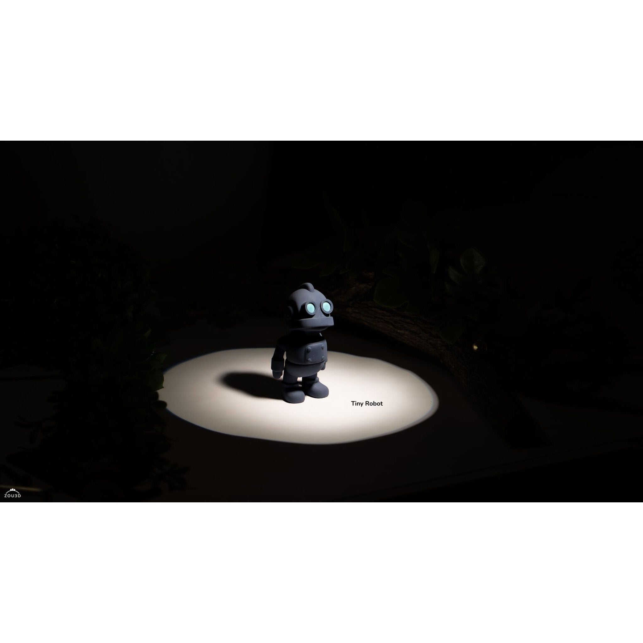 Zou3D render of Tiny Robot articulated fidget toy in grey/slate — 3/4 view showing arm and torso detail