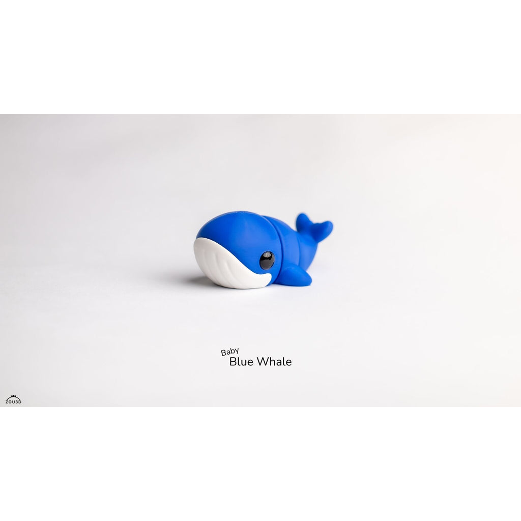 Close front three-quarter view of Baby Blue Whale 3D printed articulated toy highlighting white belly panel and large eye detail