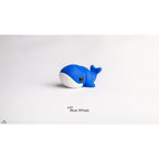 Close front three-quarter view of Baby Blue Whale 3D printed articulated toy highlighting white belly panel and large eye detail