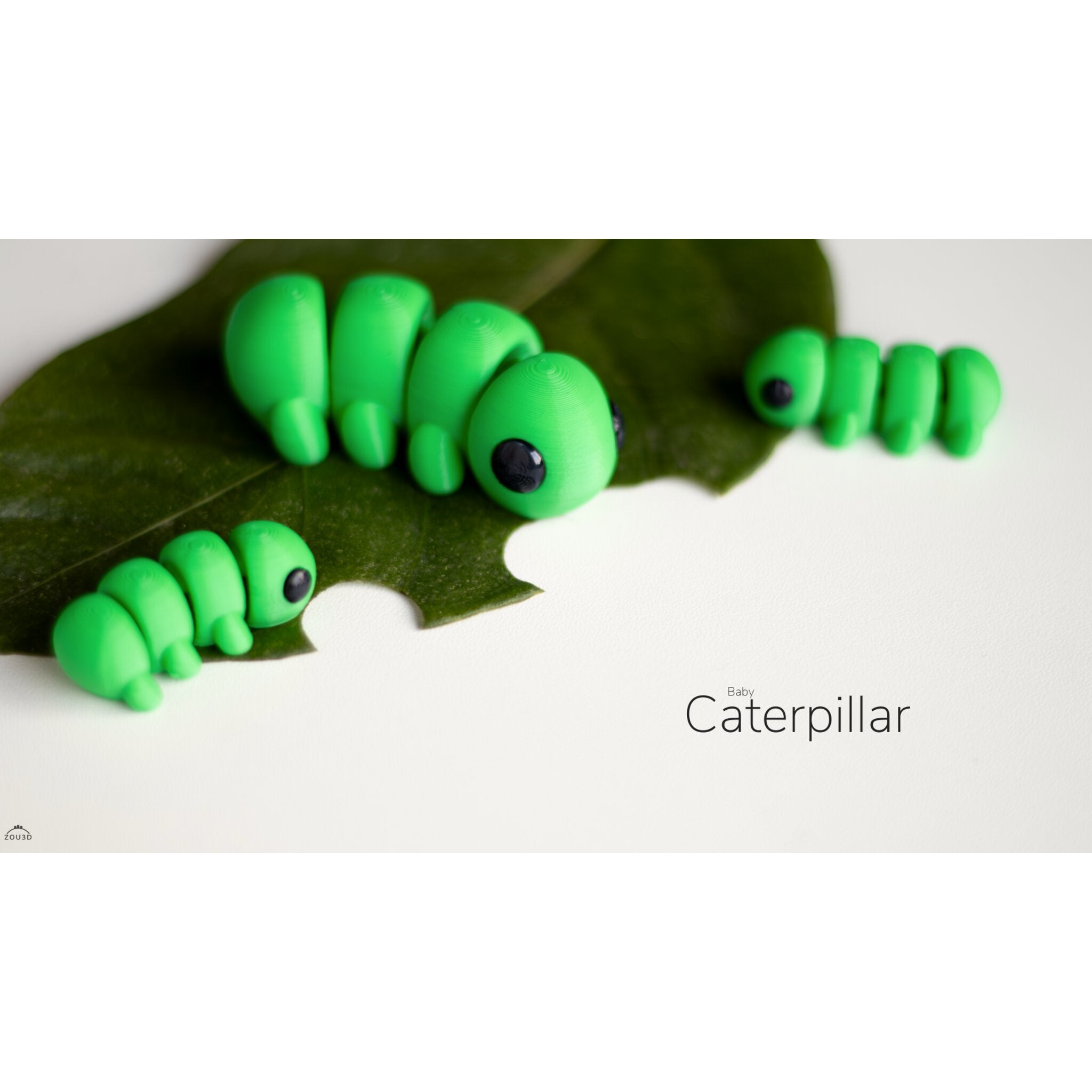 Front 3/4 view of Caterpillar 3D printed articulated fidget toy on a leaf — Zou3D design by Sensory Sidequest Australia