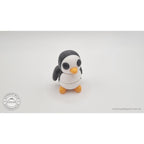 Penguin articulated fidget toy close front-facing view showing white belly, black eye patches and orange beak, white body with black and orange details — 3D printed articulated fidget toy by Sensory Sidequest