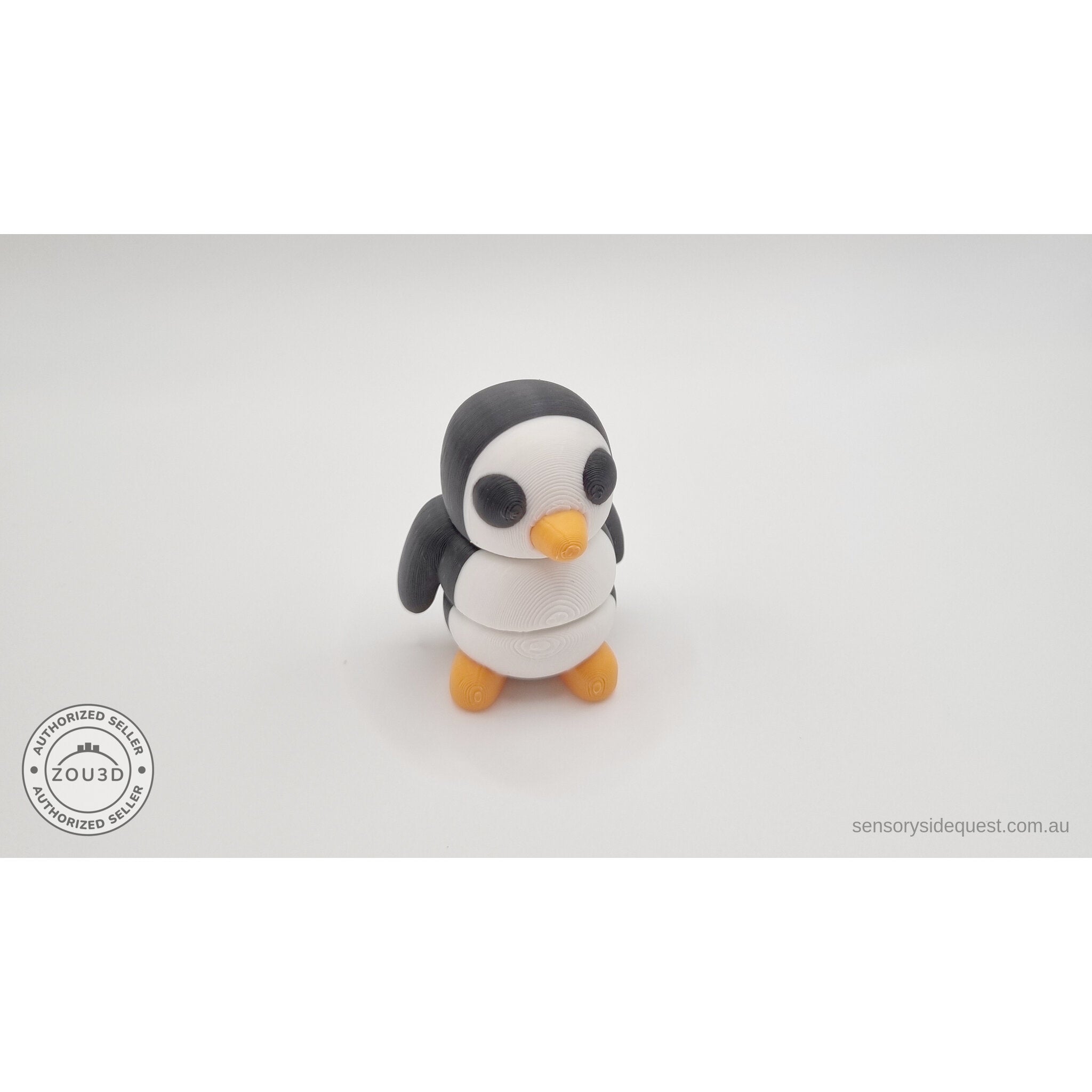 Penguin articulated fidget toy close front-facing view showing white belly, black eye patches and orange beak, white body with black and orange details — 3D printed articulated fidget toy by Sensory Sidequest