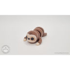 Baby Sloth 3D printed articulated fidget toy — 3/4 front view showing face, cream mask, and long arms, own photo by Sensory Sidequest