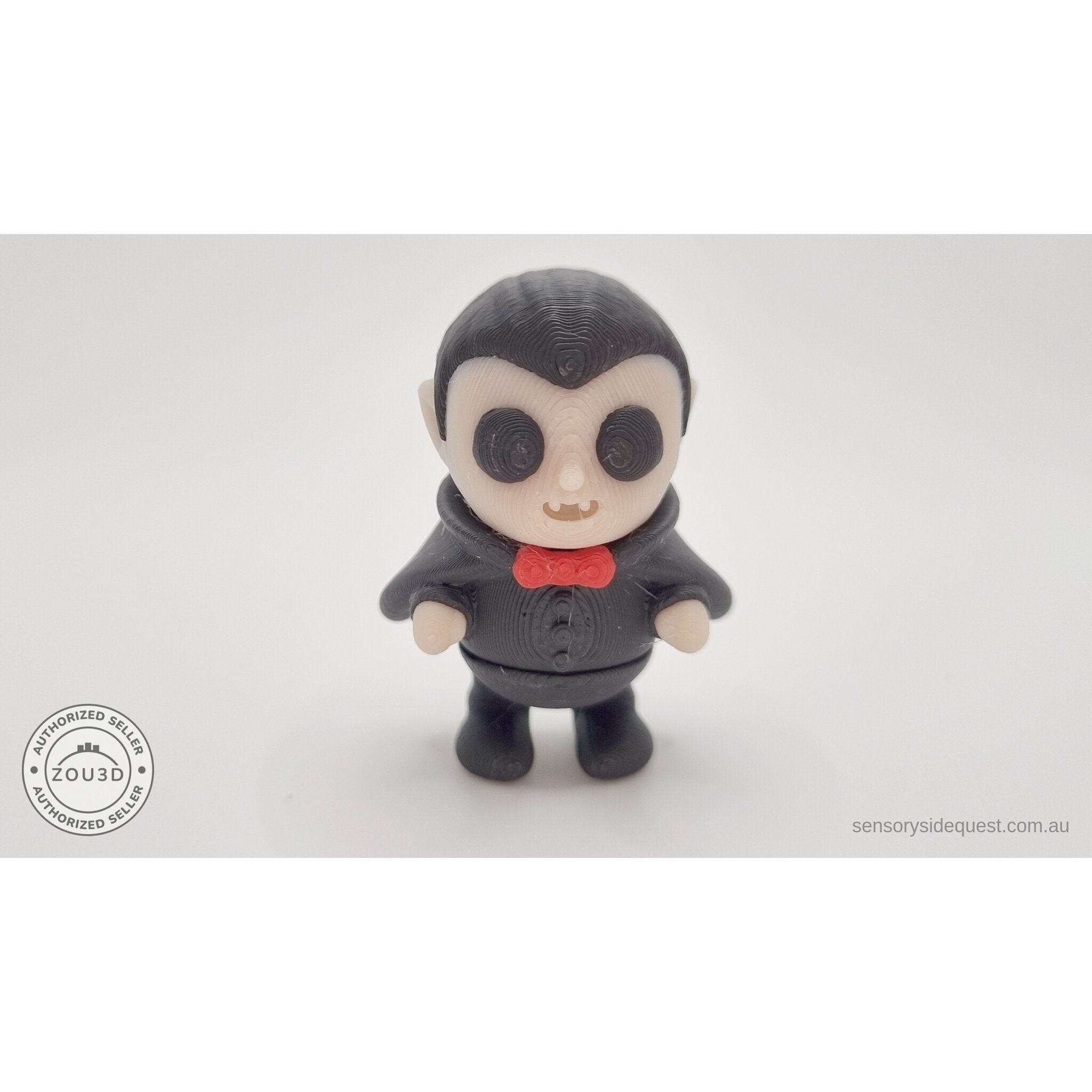 Tiny Dracula 3D printed articulated fidget toy — straight front view showing face, red bow tie, and full figure, own photo by Sensory Sidequest