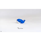 Side view of Baby Blue Whale articulated fidget toy showing body segments and tail flukes raised, demonstrating articulation joints