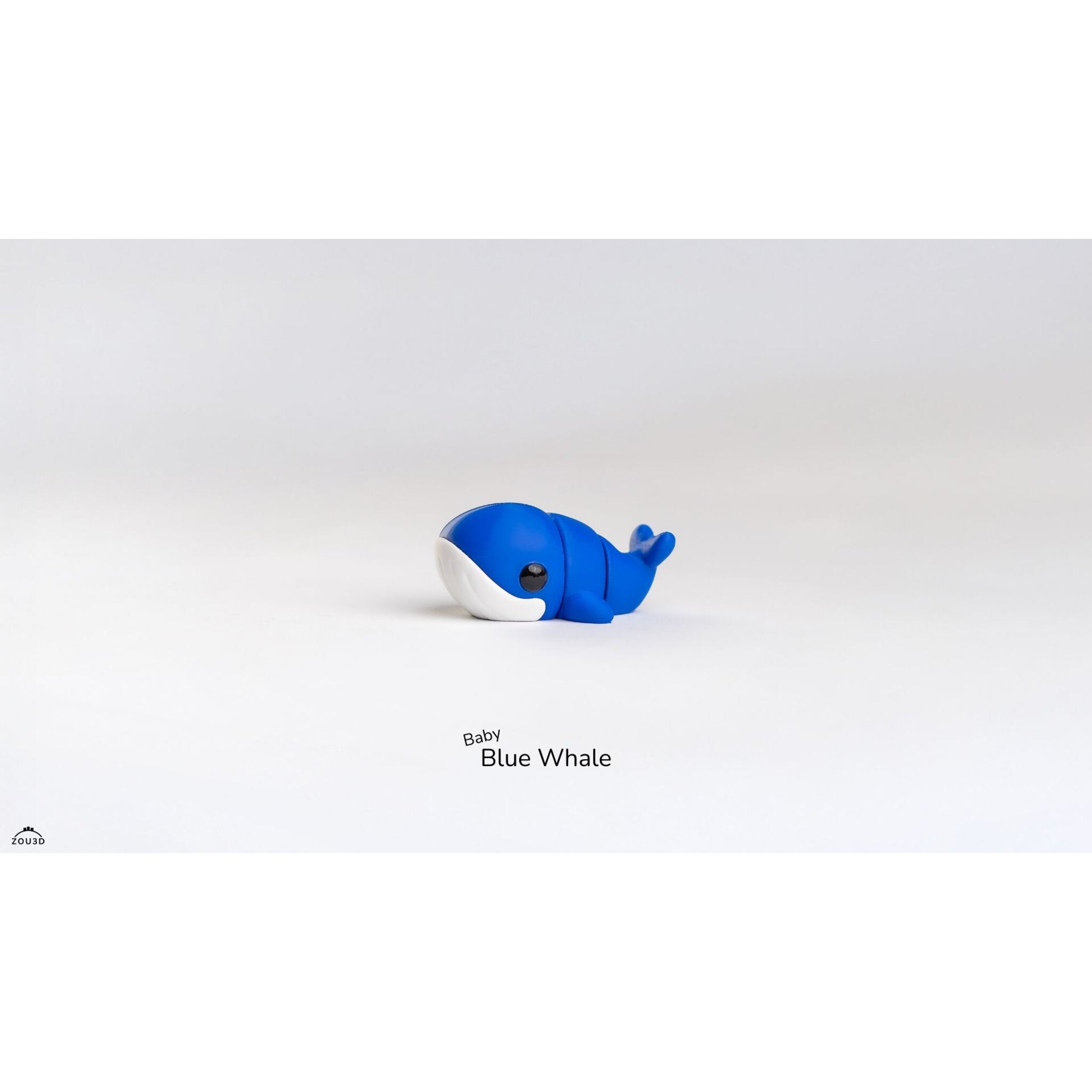 Side view of Baby Blue Whale articulated fidget toy showing body segments and tail flukes raised, demonstrating articulation joints