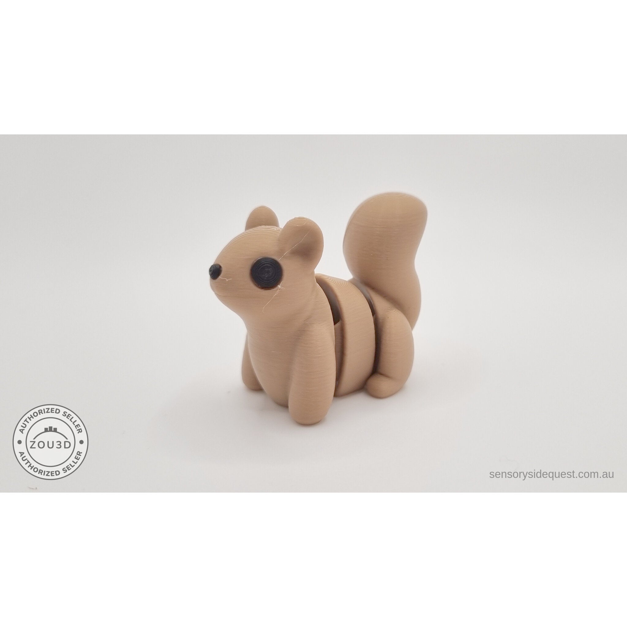 Baby Squirrel Zou3D 3D printed articulated fidget toy — 3/4 front view showing warm golden-brown colouring, expressive eyes, and arching sculptured tail — Sensory Sidequest Australia