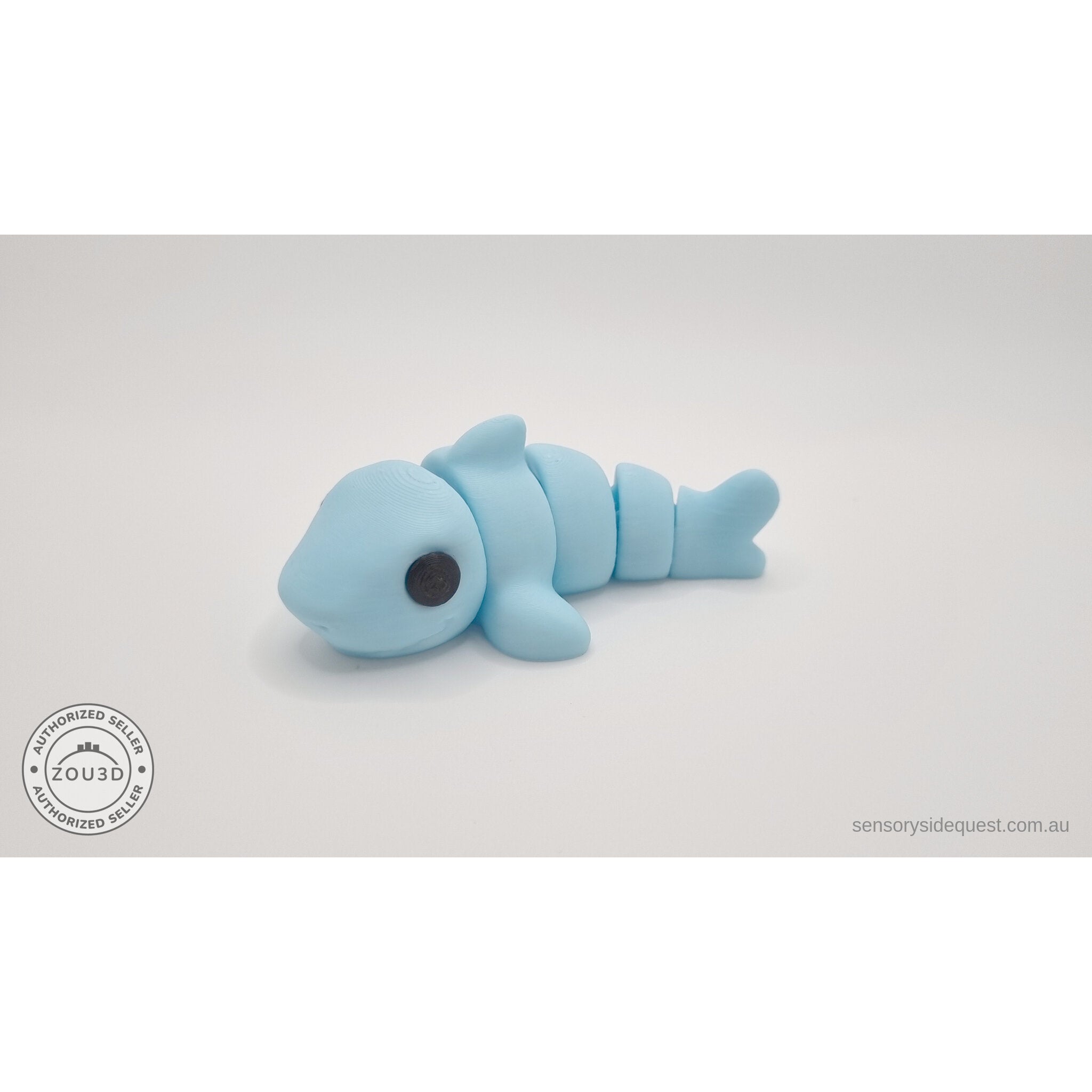 024-SHK Baby Shark in ice blue matte, 3/4 lying side view — 3D printed articulated fidget toy by Sensory Sidequest