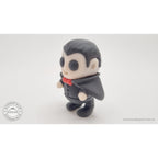 Tiny Dracula articulated toy — 3/4 left view showing cape sweep and figure detail, own photo by Sensory Sidequest