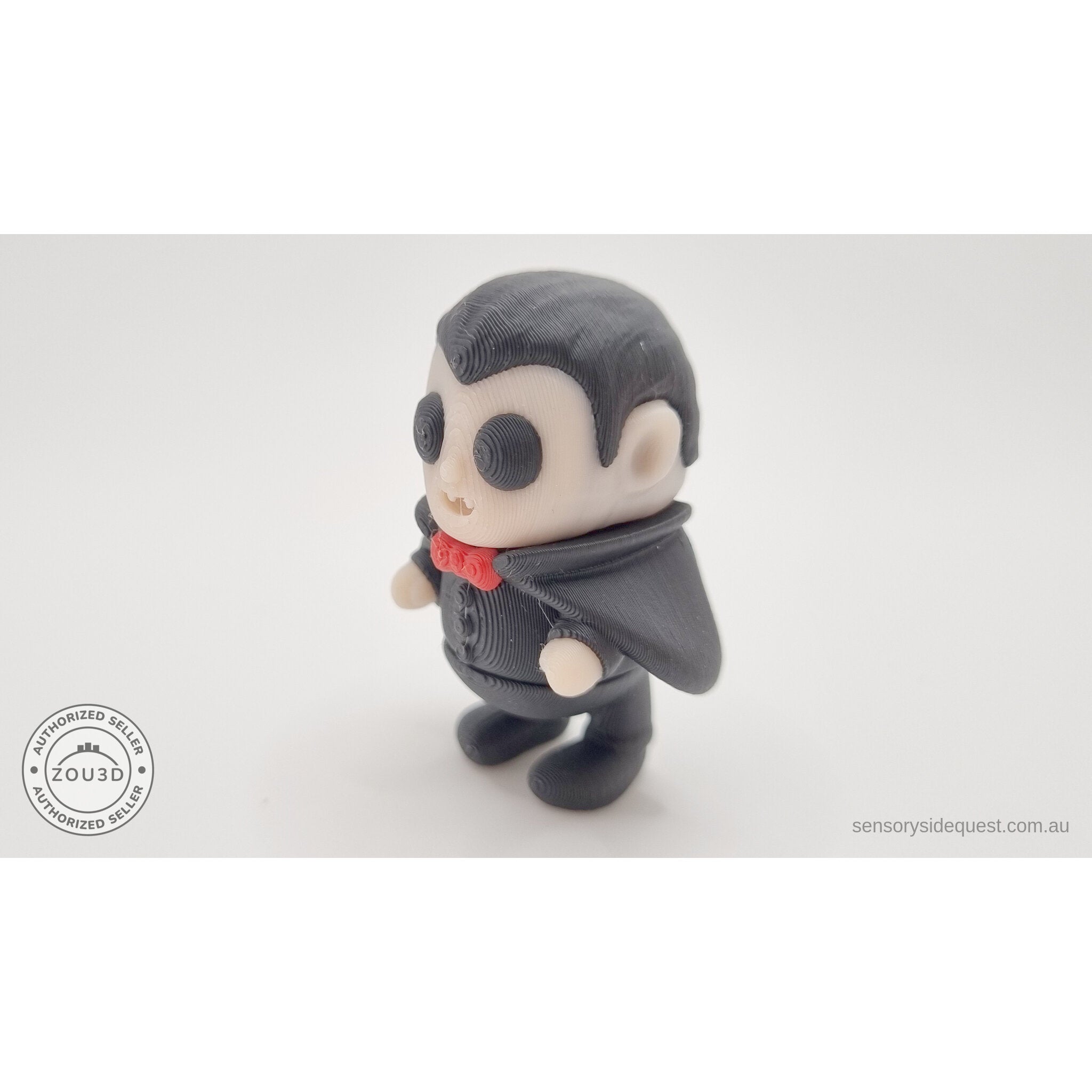 Tiny Dracula articulated toy — 3/4 left view showing cape sweep and figure detail, own photo by Sensory Sidequest