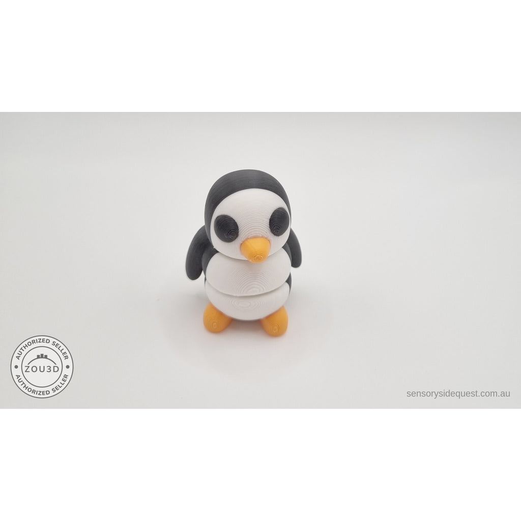 Penguin articulated fidget toy overhead flat lay showing front face, white body with black head markings and orange beak — 3D printed articulated fidget toy by Sensory Sidequest