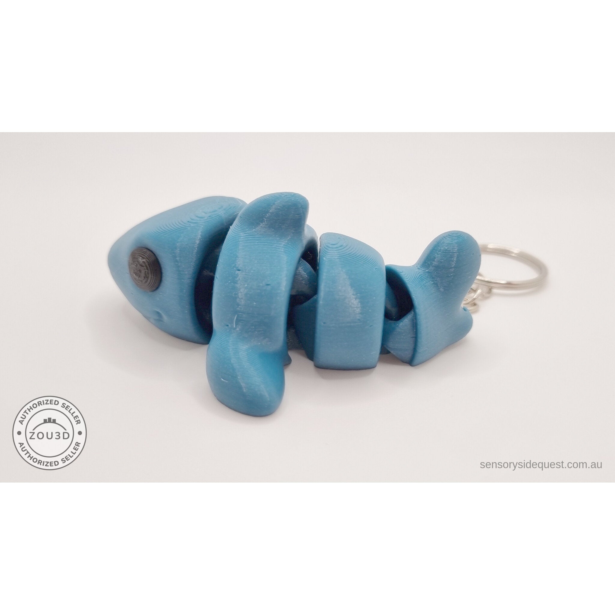 027-TNYSHK Tiny Shark keychain in gentian blue — side view with body fully extended flat, all segments and keychain visible — 3D printed articulated fidget toy by Sensory Sidequest