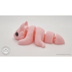 Pink Tiny Dragon 3D printed toy — right-facing side view showing articulation segments and tail — Sensory Sidequest Australia