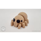 Baby Spider articulated fidget toy — front three-quarter view showing all eight legs and expressive chibi eyes