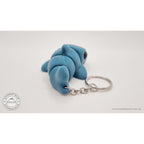 027-TNYSHK Tiny Shark keychain in gentian blue — side view with body slightly curved, showing segment articulation and keychain ring — 3D printed articulated fidget toy by Sensory Sidequest