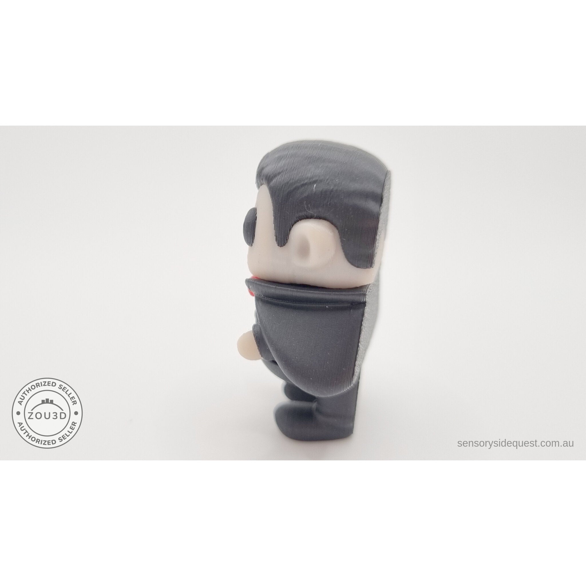 Tiny Dracula 3D printed fidget toy — left side profile view showing figure silhouette and cape, own photo by Sensory Sidequest