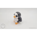 Penguin articulated fidget toy overhead flat lay showing white belly and back, black wings and orange feet visible — 3D printed articulated fidget toy by Sensory Sidequest