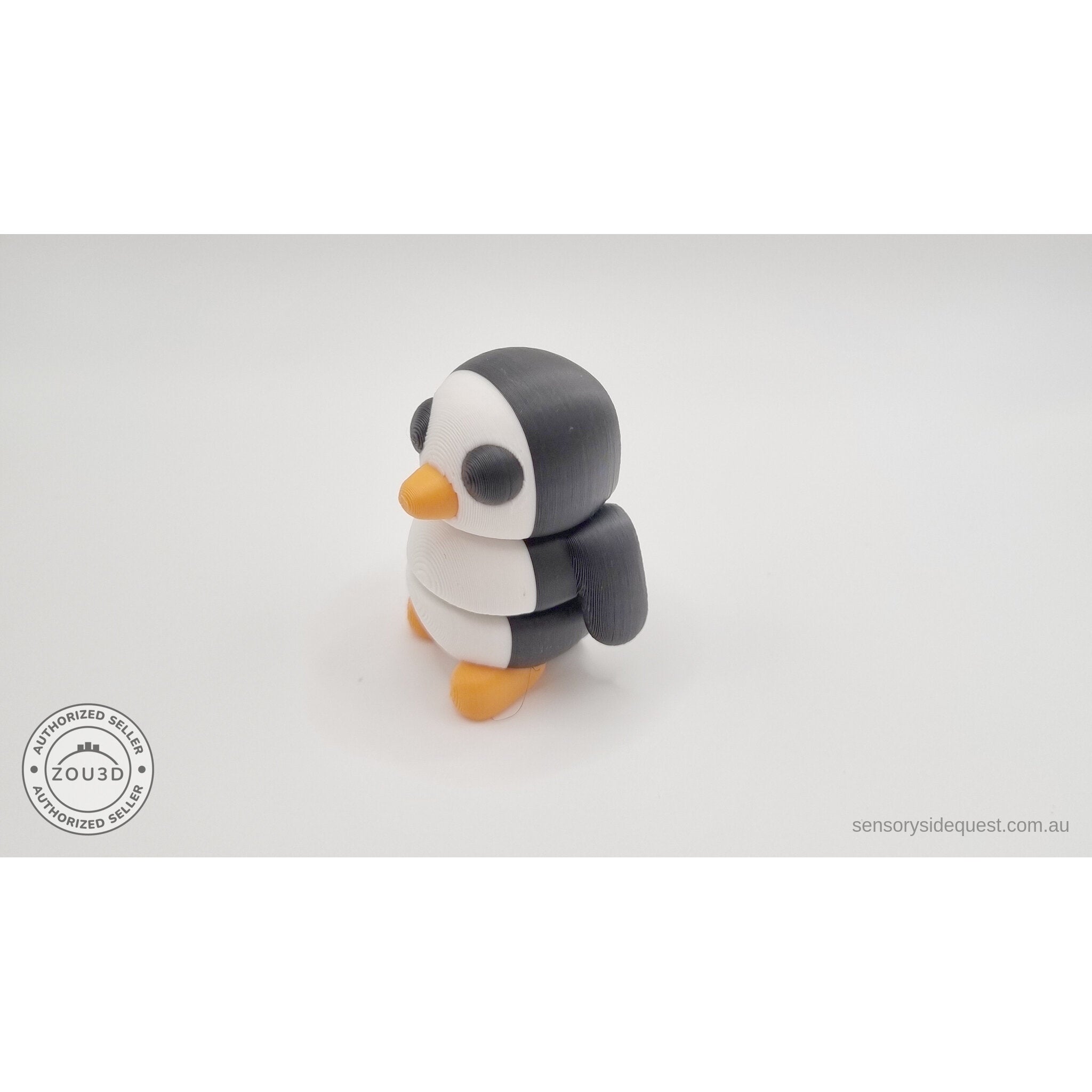 Penguin articulated fidget toy overhead flat lay showing white belly and back, black wings and orange feet visible — 3D printed articulated fidget toy by Sensory Sidequest