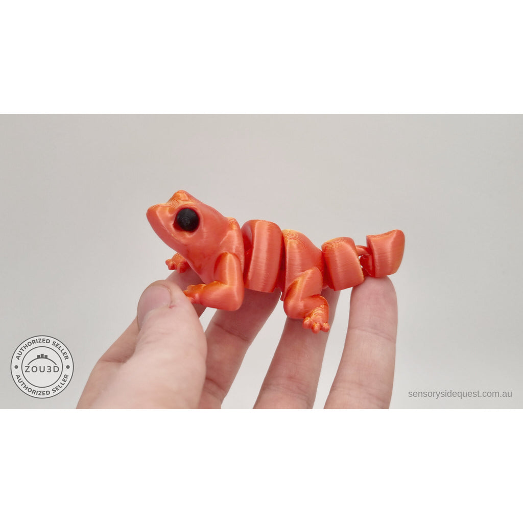 Red-gold Baby Lizard 3D printed articulated fidget toy held in hand — showing palm size — Sensory Sidequest
