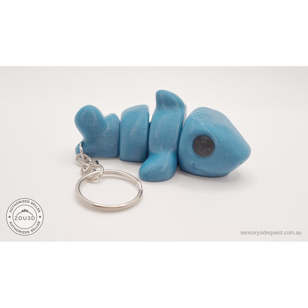 027-TNYSHK Tiny Shark keychain in gentian blue — rear view showing tail segment and keychain chain attachment point — 3D printed articulated fidget toy by Sensory Sidequest