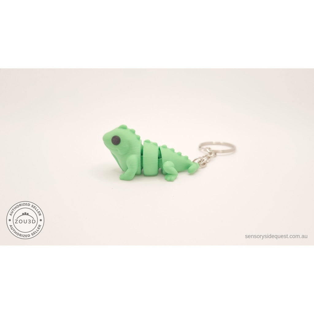 Green Baby Iguana keychain — side profile showing articulated body segments by Sensory Sidequest