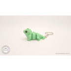 Green Baby Iguana keychain — side profile showing articulated body segments by Sensory Sidequest