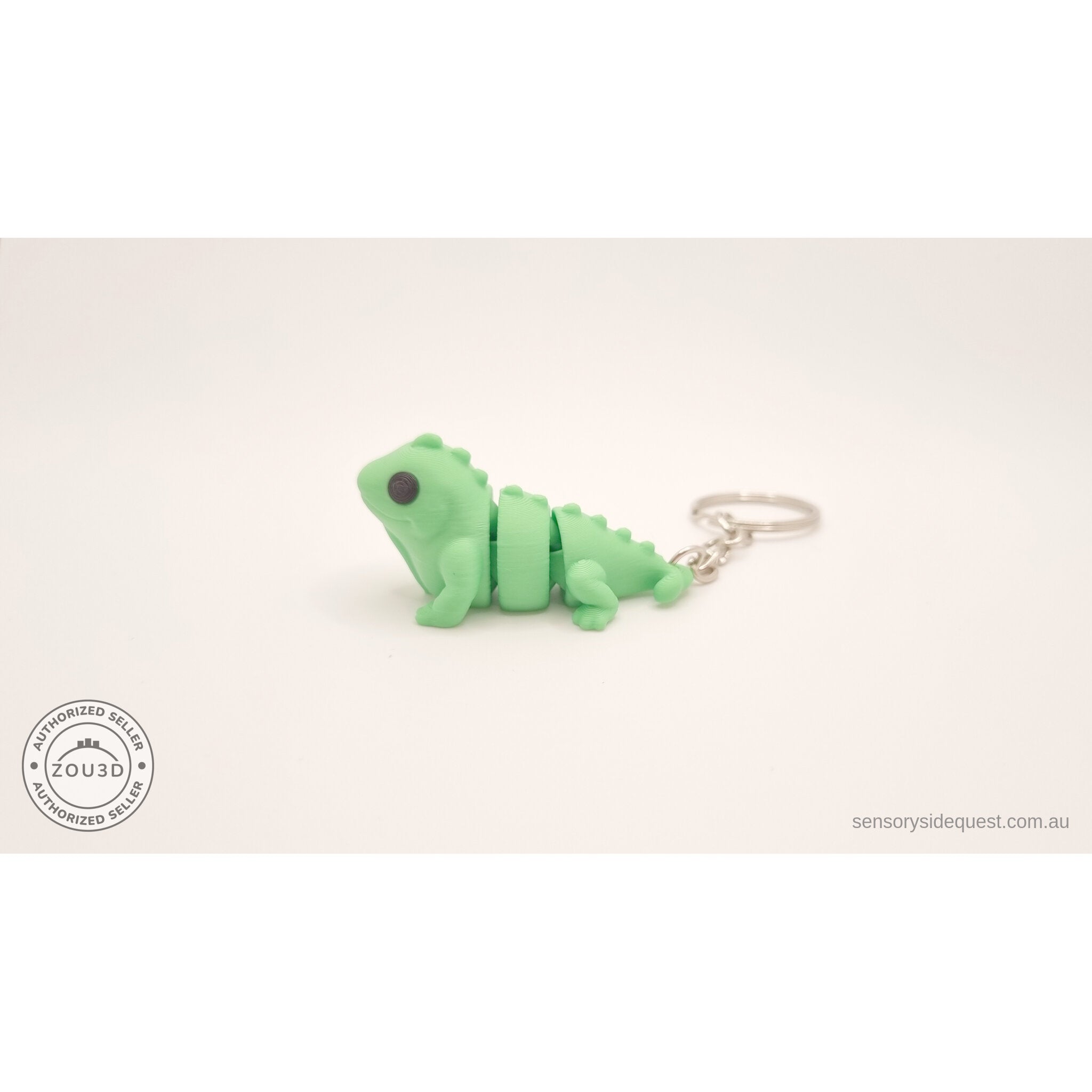 Green Baby Iguana keychain — side profile showing articulated body segments by Sensory Sidequest