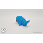 Baby Blue Whale 3D printed fidget toy — 3/4 right side view showing tail flukes and body segments, own photo by Sensory Sidequest
