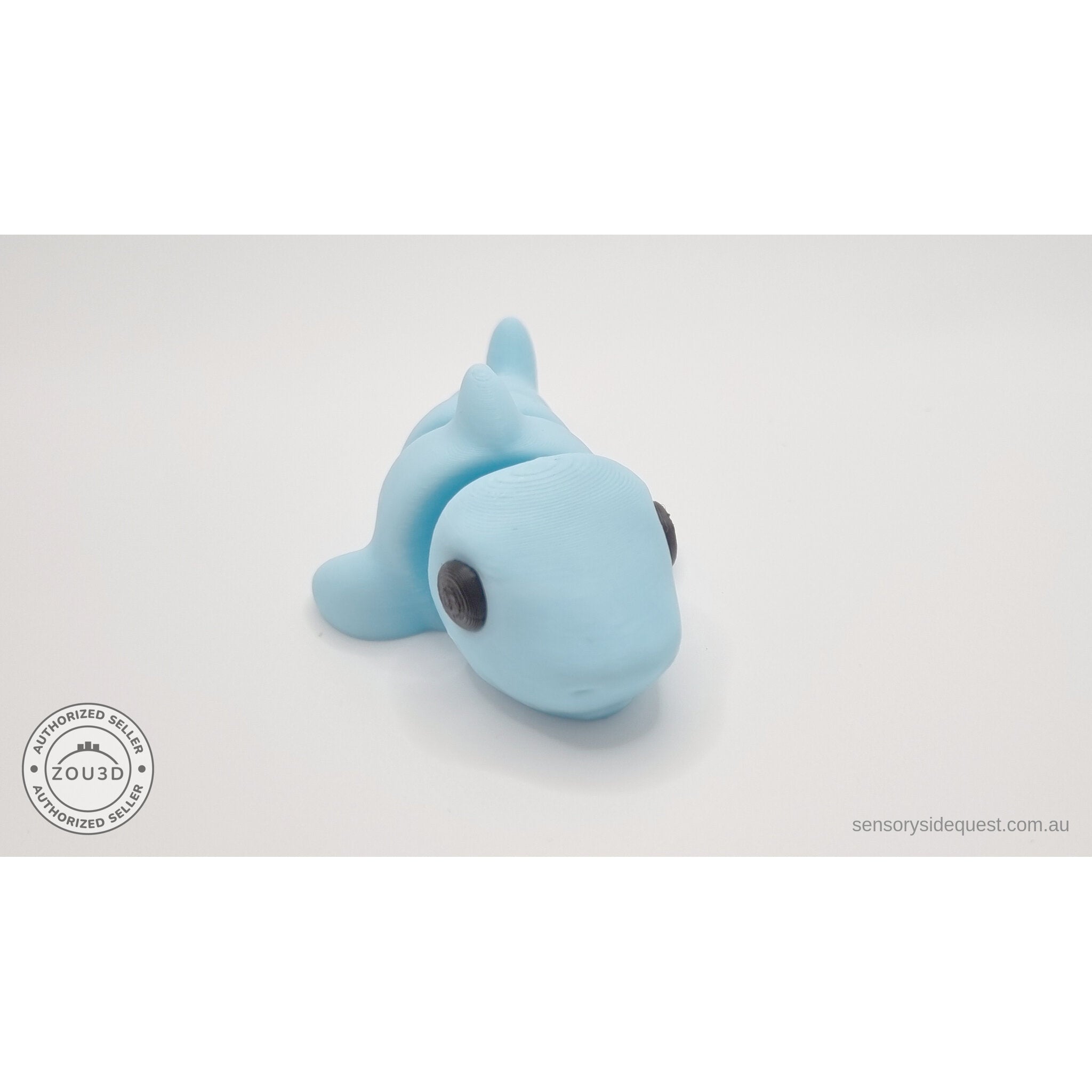 024-SHK Baby Shark in ice blue matte, 3/4 rear/curled view showing tail segments — 3D printed articulated fidget toy by Sensory Sidequest