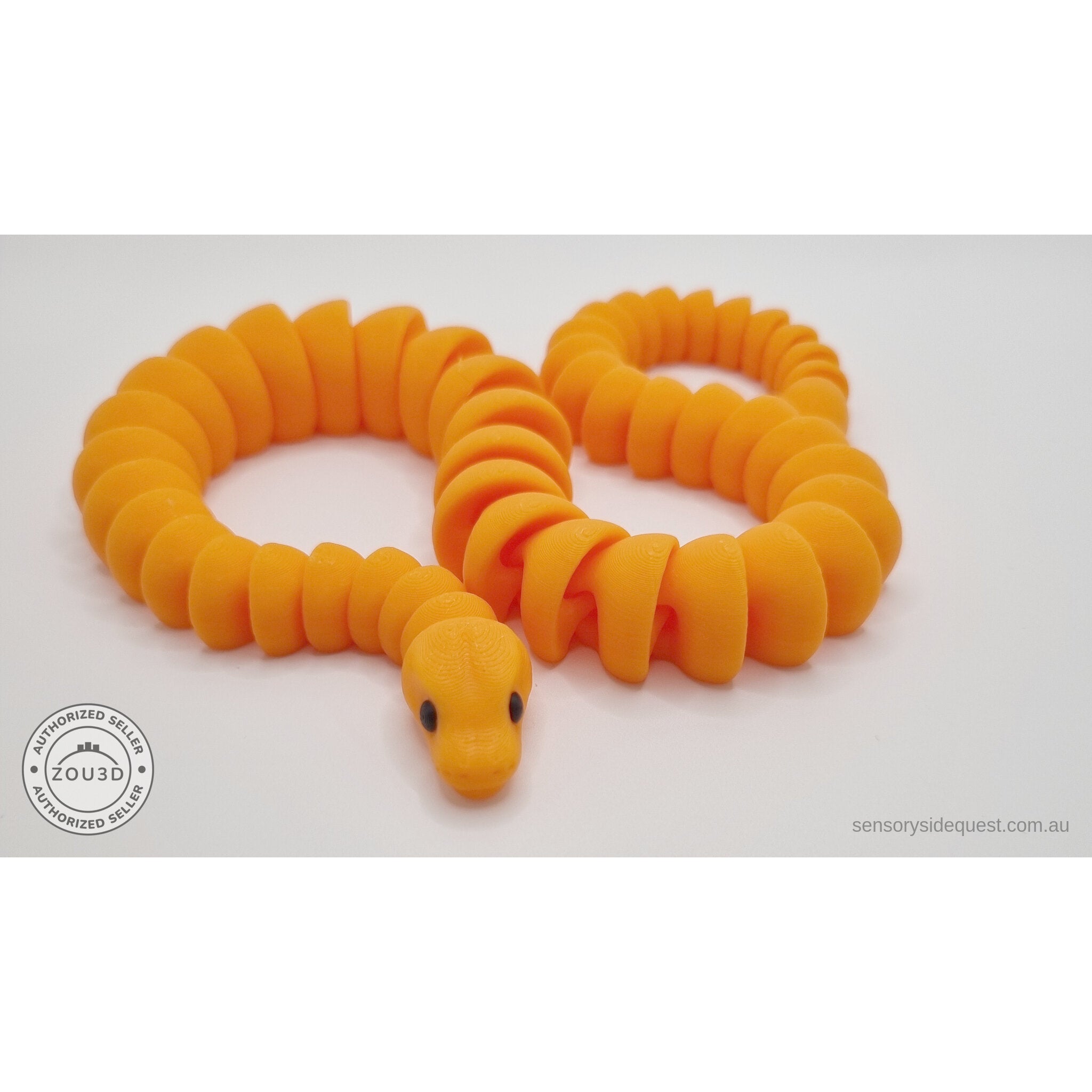 Close-up of orange 3D printed ball python fidget toy showing the cute head detail and articulated joint segments