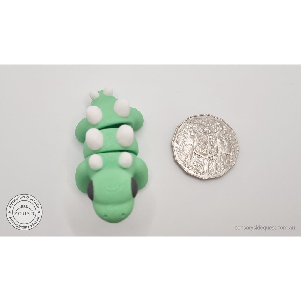 Baby Stegosaurus beside Australian 50 cent coin — overhead scale reference