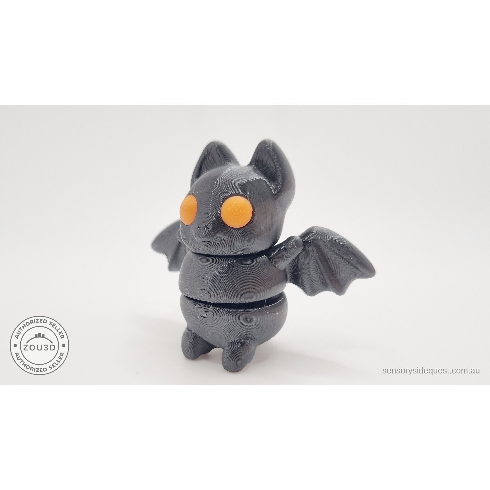 Tiny Bat articulated fidget toy — orange eye variant, front-facing view