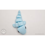 024-SHK Baby Shark in ice blue matte, upright vertical twisted pose showing full flex range — 3D printed fidget toy by Sensory Sidequest