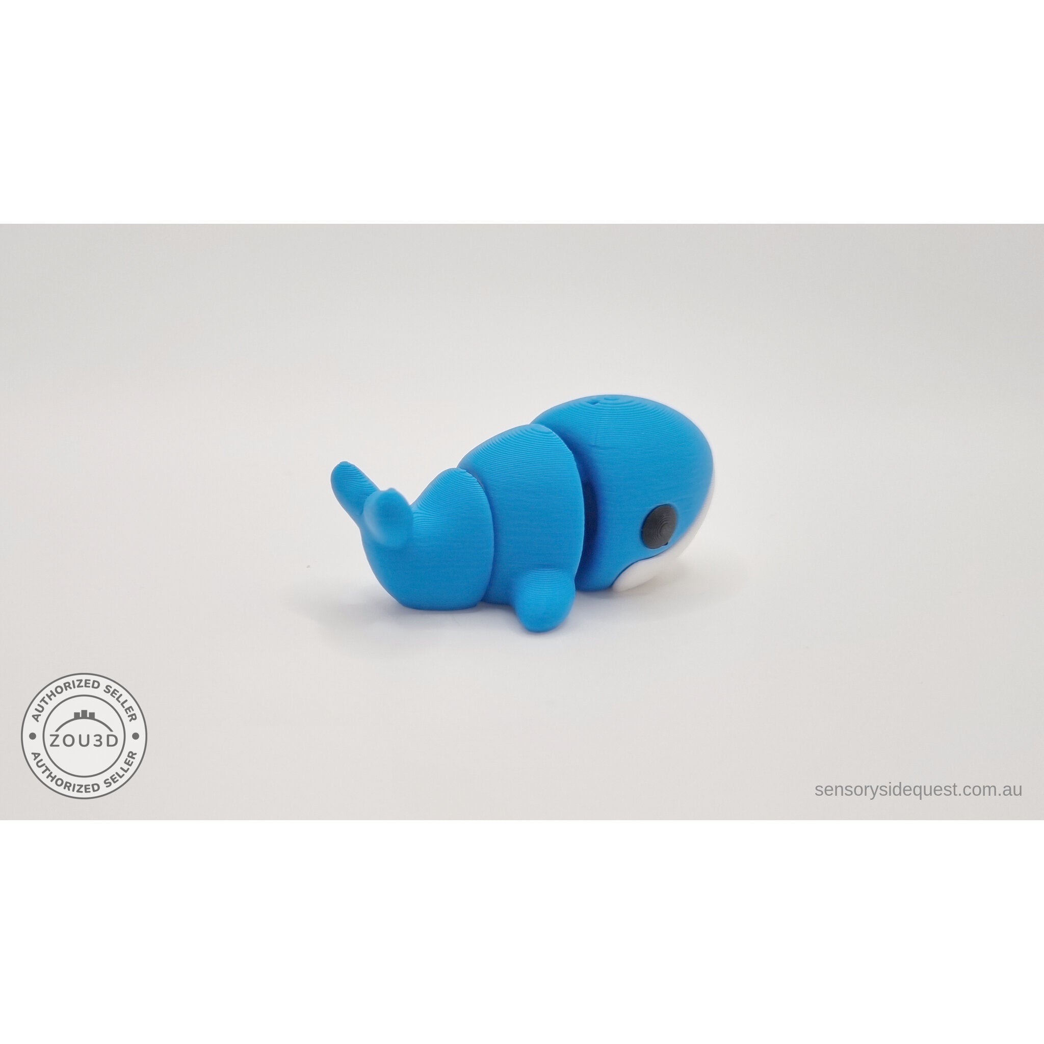 Baby Blue Whale articulated toy — rear right 3/4 angle showing tail detail and body articulation joints, own photo by Sensory Sidequest