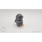 Penguin articulated fidget toy close 3/4 left profile view, white and black colouring with orange beak and feet clearly visible — 3D printed articulated fidget toy by Sensory Sidequest