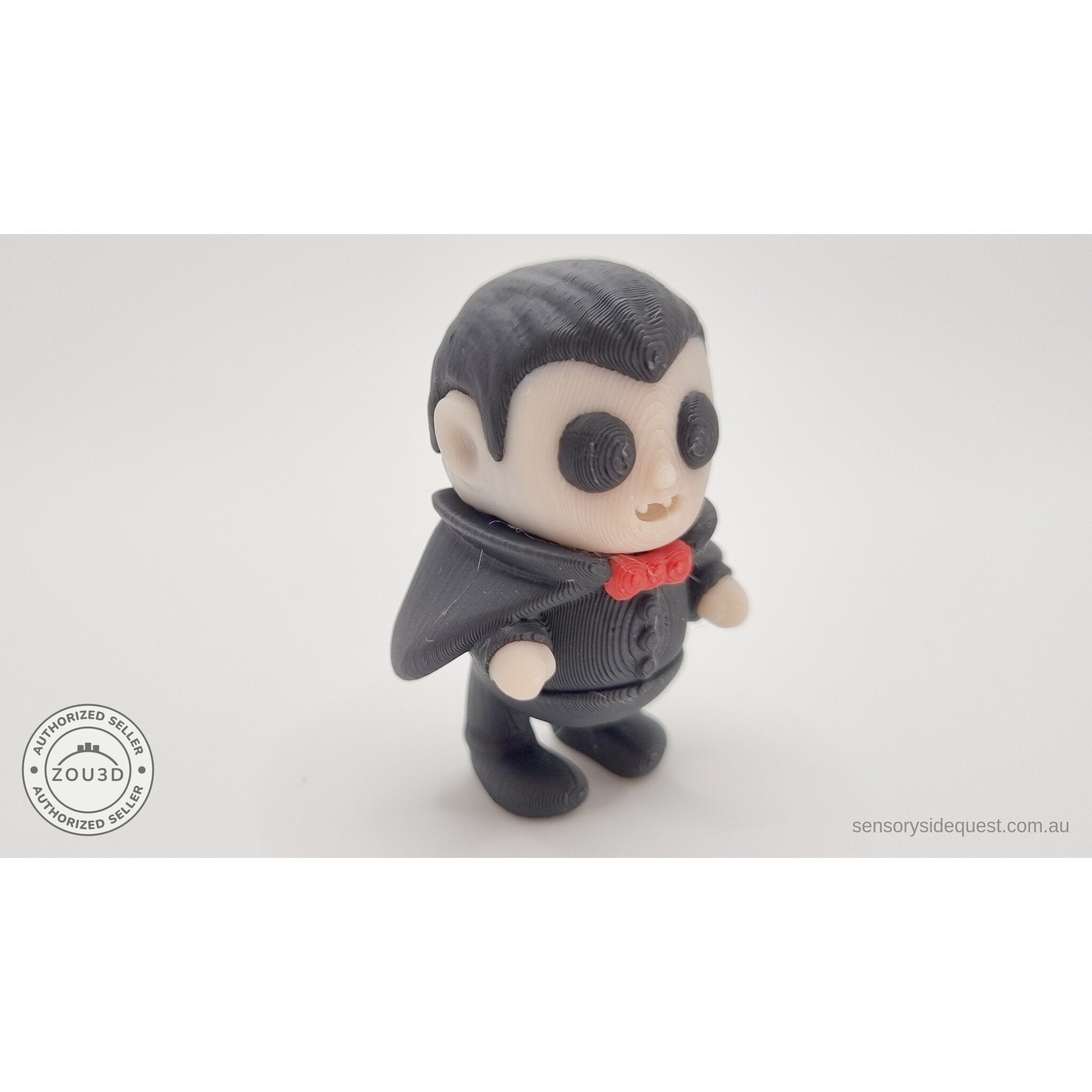 Tiny Dracula 3D printed articulated fidget toy — 3/4 right view showing cape and red bow tie accent, own photo by Sensory Sidequest