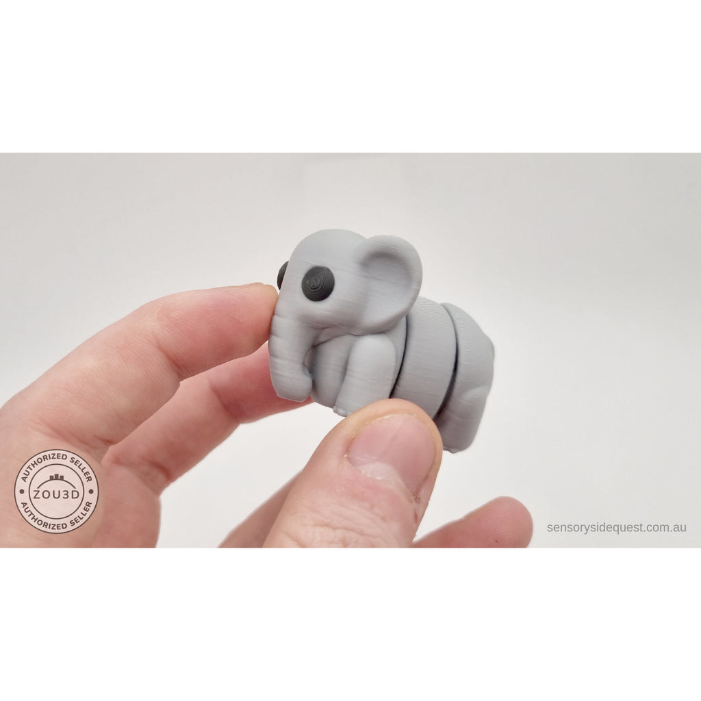 Grey Baby Elephant 3D printed articulated fidget toy held in hand — scale reference