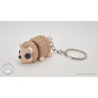 Baby Hedgehog articulated fidget toy with keychain — 3/4 front view showing full figure and key ring, own photo by Sensory Sidequest