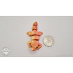Red-gold Baby Lizard 3D printed articulated fidget toy beside Australian 50 cent coin — scale reference — Sensory Sidequest