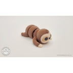Baby Sloth 3D printed articulated fidget toy — front low angle showing face and paw tips, own photo by Sensory Sidequest