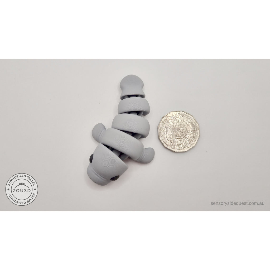 Baby Manatee 3D printed articulated fidget toy with 50 cent coin for scale by Sensory Sidequest