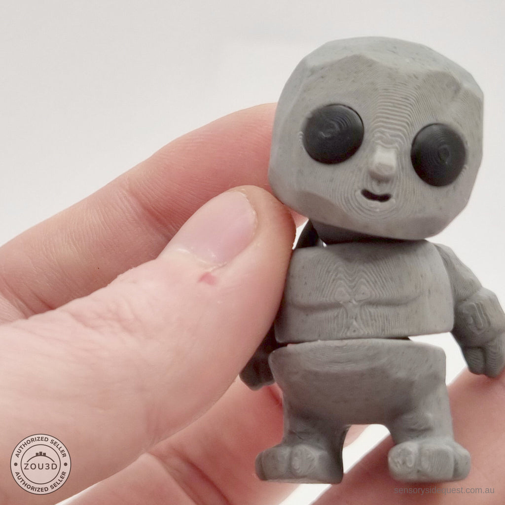 Grey Tiny Rock Golem 3D printed articulated fidget toy held in hand — scale reference