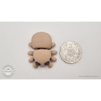 Baby Spider beside Australian 50 cent coin — overhead scale reference showing compact size