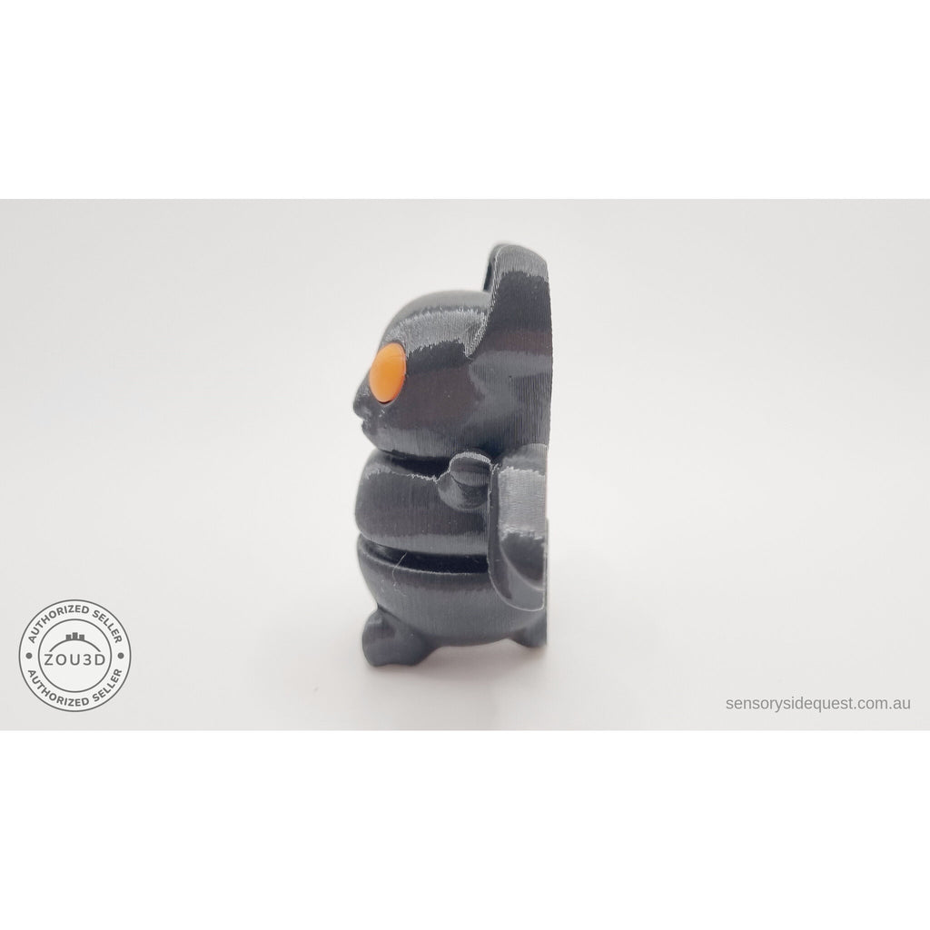 Tiny Bat with orange eyes — side profile showing poseable wing and articulated body