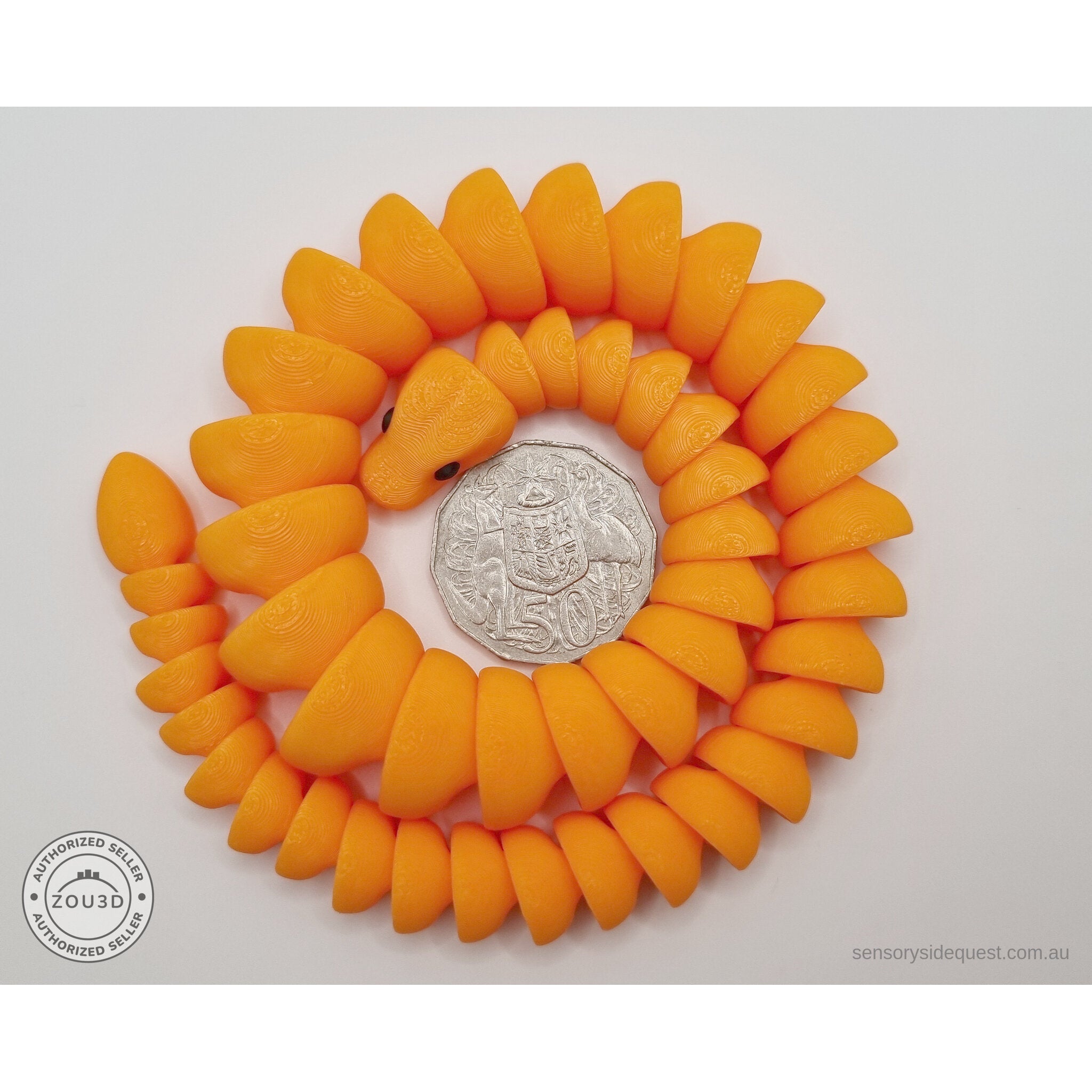 Orange 3D printed ball python fidget toy coiled in a tight spiral with Australian 50 cent coin in the centre — overhead scale reference